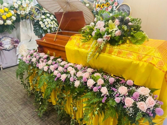 Surrounding casket flowers