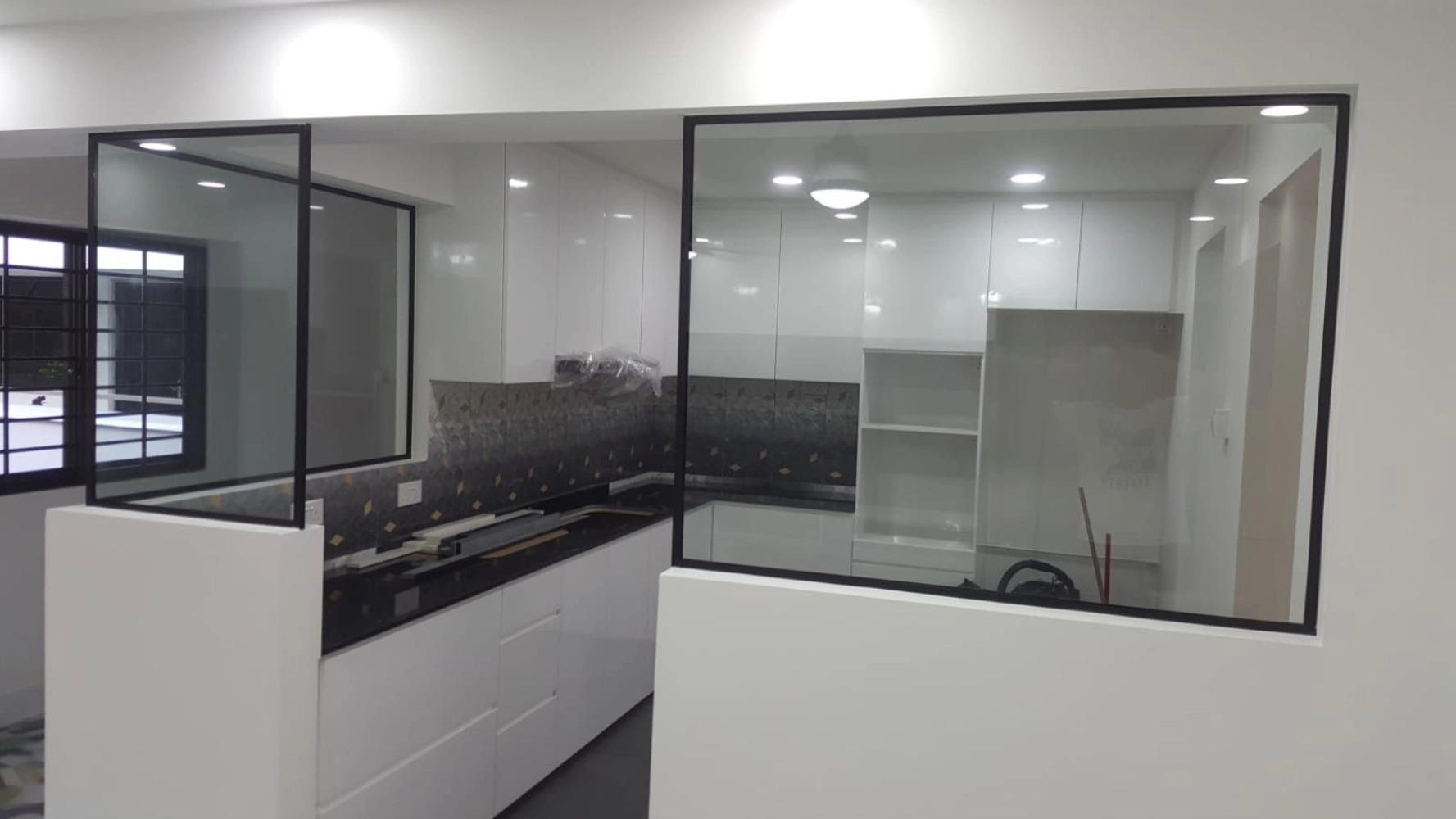 Semi-open kitchen with tempered glass partition separating wet and dry kitchen Malaysia