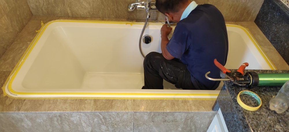 Toilet leaking repair seal with sealant silicone at marble tiles