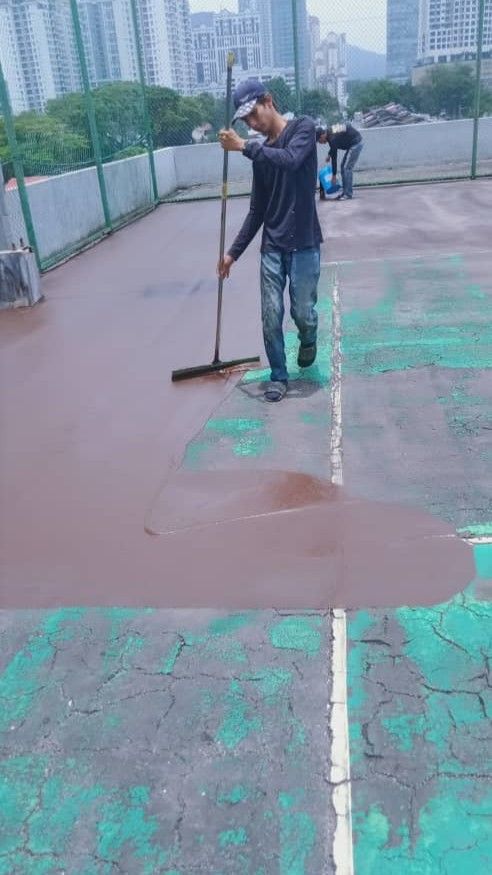 Application Of 1st Layer Of Bitumen Mastic Base Cushioning Coat By Rubber Squeegee Tool In Progress