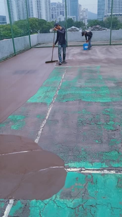 Application Of 1st Layer Of Bitumen Mastic Base Cushioning Coat By Rubber Squeegee Tool In Progress