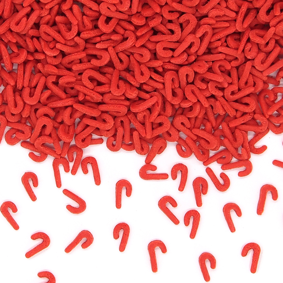 Industrial bulk natural candy cane-shaped sprinkles colored with paprika extract for wholesale.