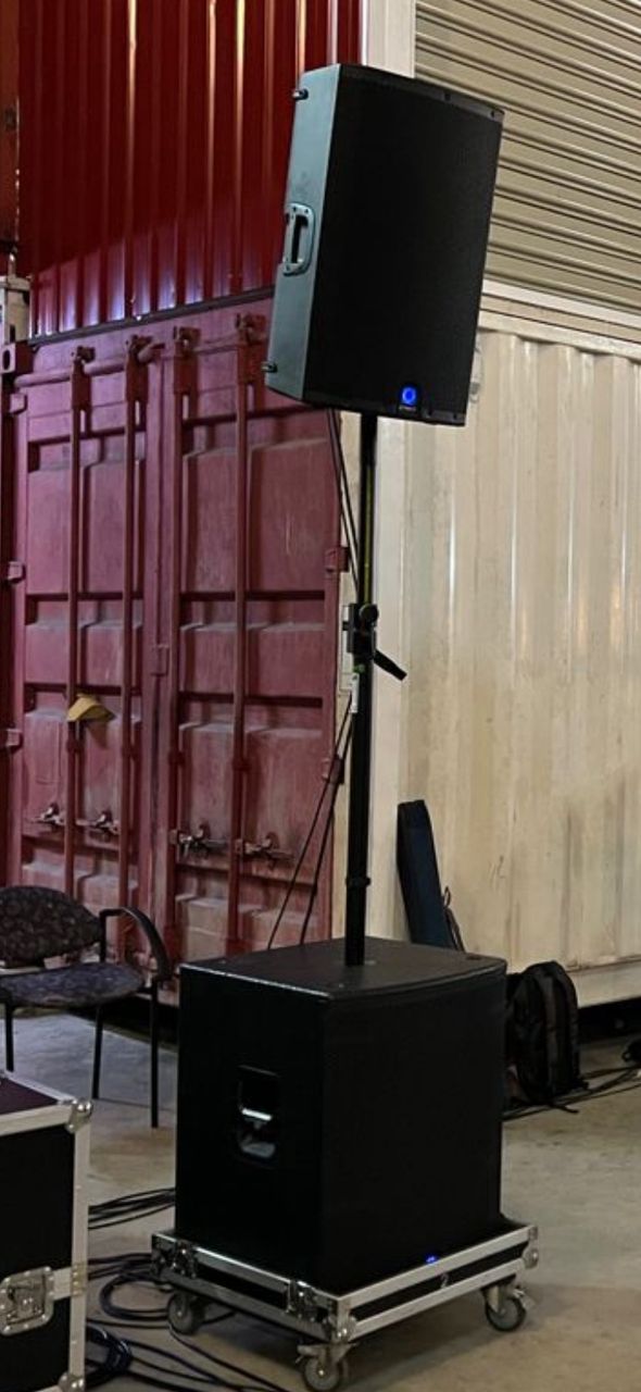 Turbosound iQ15 active speaker and iQ18B powered subwoofer setup, ideal for space-saving event control areas.